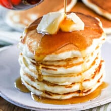 pouring syrup over Fluffy Pancakes
