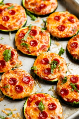 zucchini pizza bites on a pan with basil on top