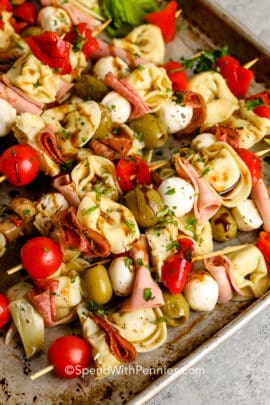 antipasto skewers on a baking sheet