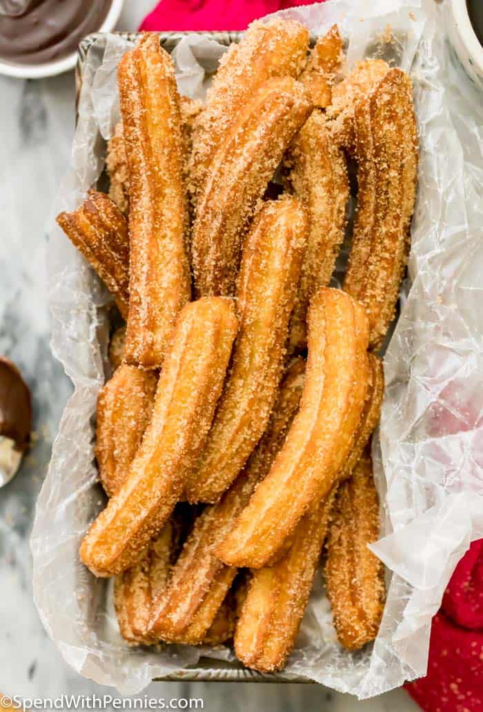 Churros in a pan with parchment paper