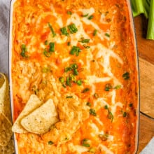 baked buffalo chicken dip with tortilla chips and celery