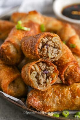 cooked Crispy Homemade Egg Rolls with one open in half