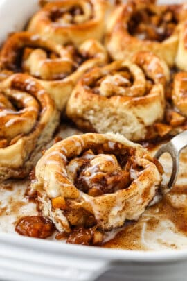close up of baked Easy Apple Cinnamon Rolls in a baking dish
