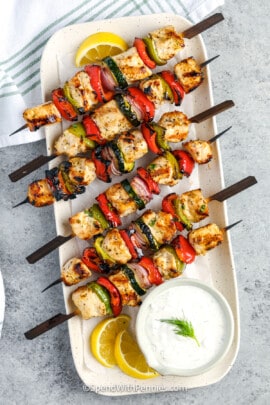 cooked greek chicken kabobs on a plate