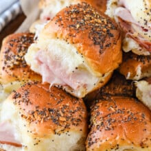 A plate of baked ham and cheese sliders