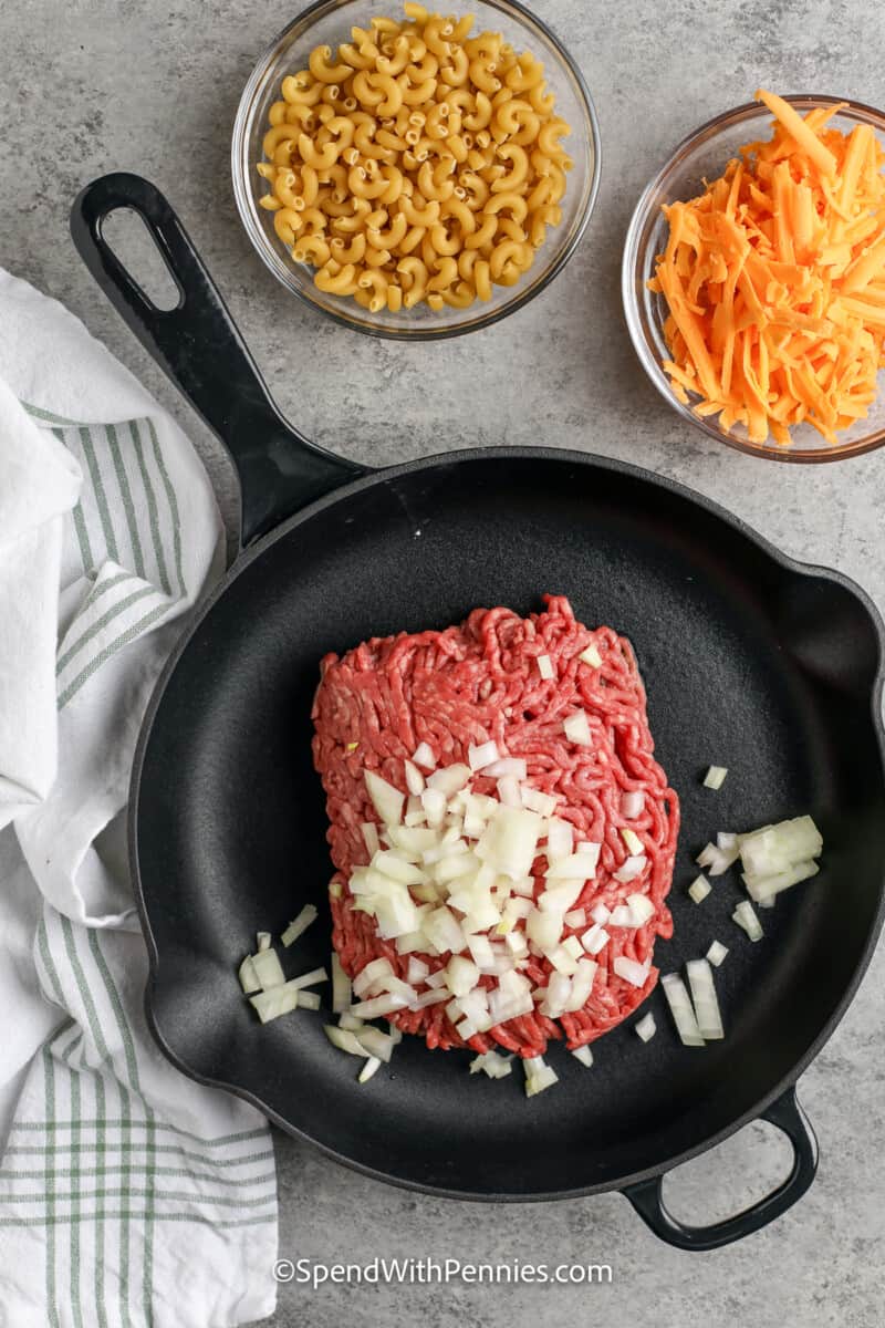 ground beef and onions in a cast iron pan