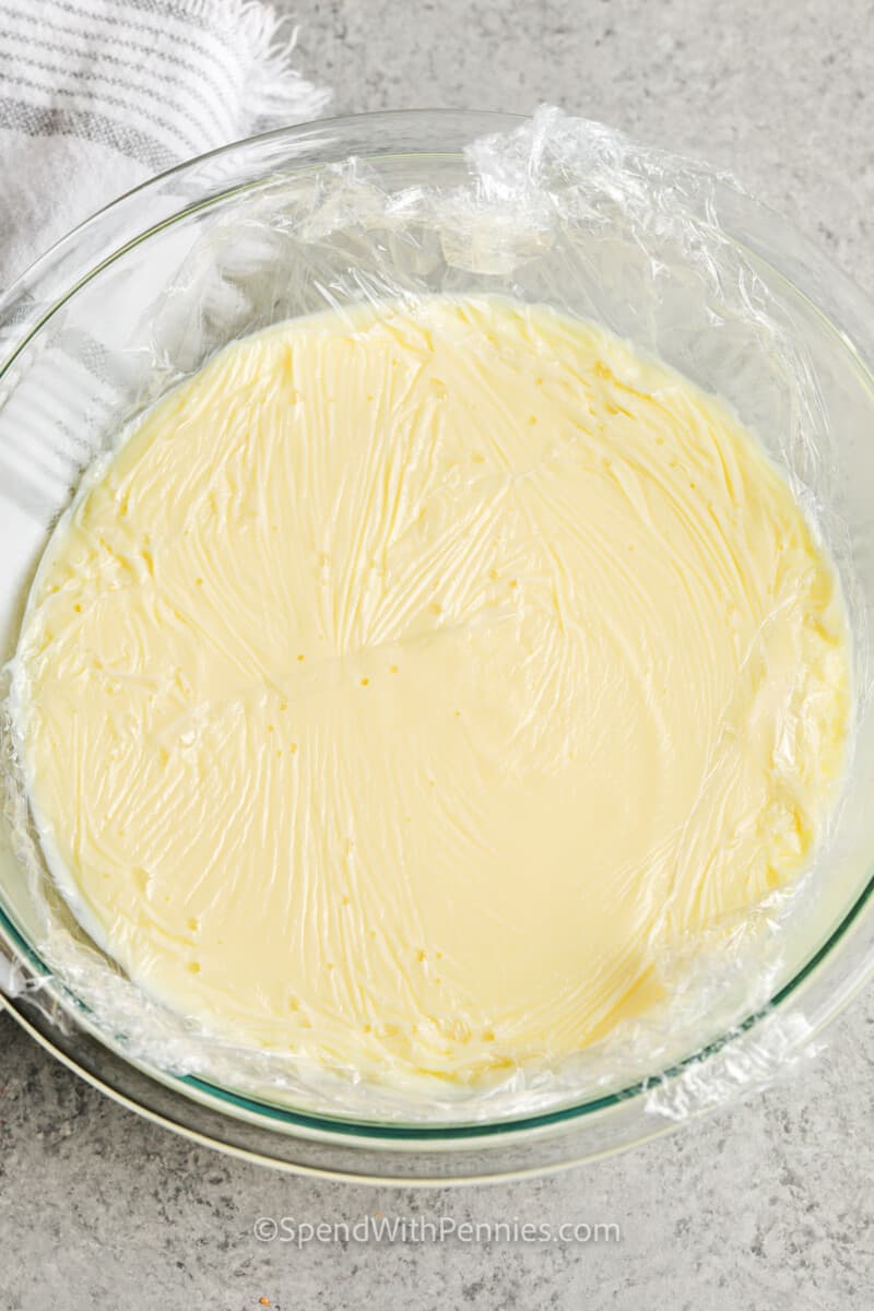 Homemade Vanilla Custard in a bowl with saran wrap before setting