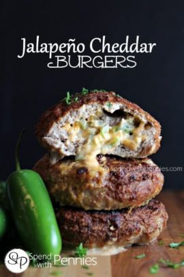 a stack of Jalapeno Cheddar Burgers with cheese oozing out and a jalapeño on the side