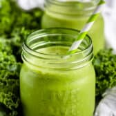Kale Smoothie in two mason jars with straws