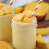 Mango Smoothie in glass with a straw