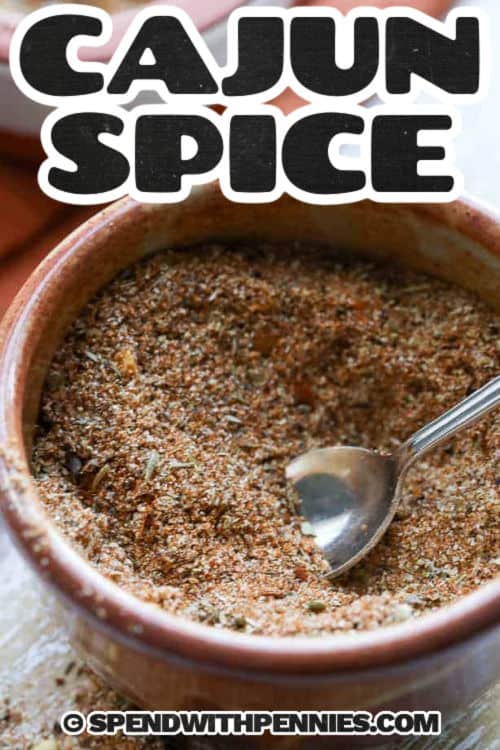 Cajun Seasoning in a bowl with a spoon and a title