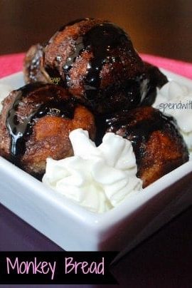 nutella stuffed monkey bread with sauce and dipping cream in a white dish