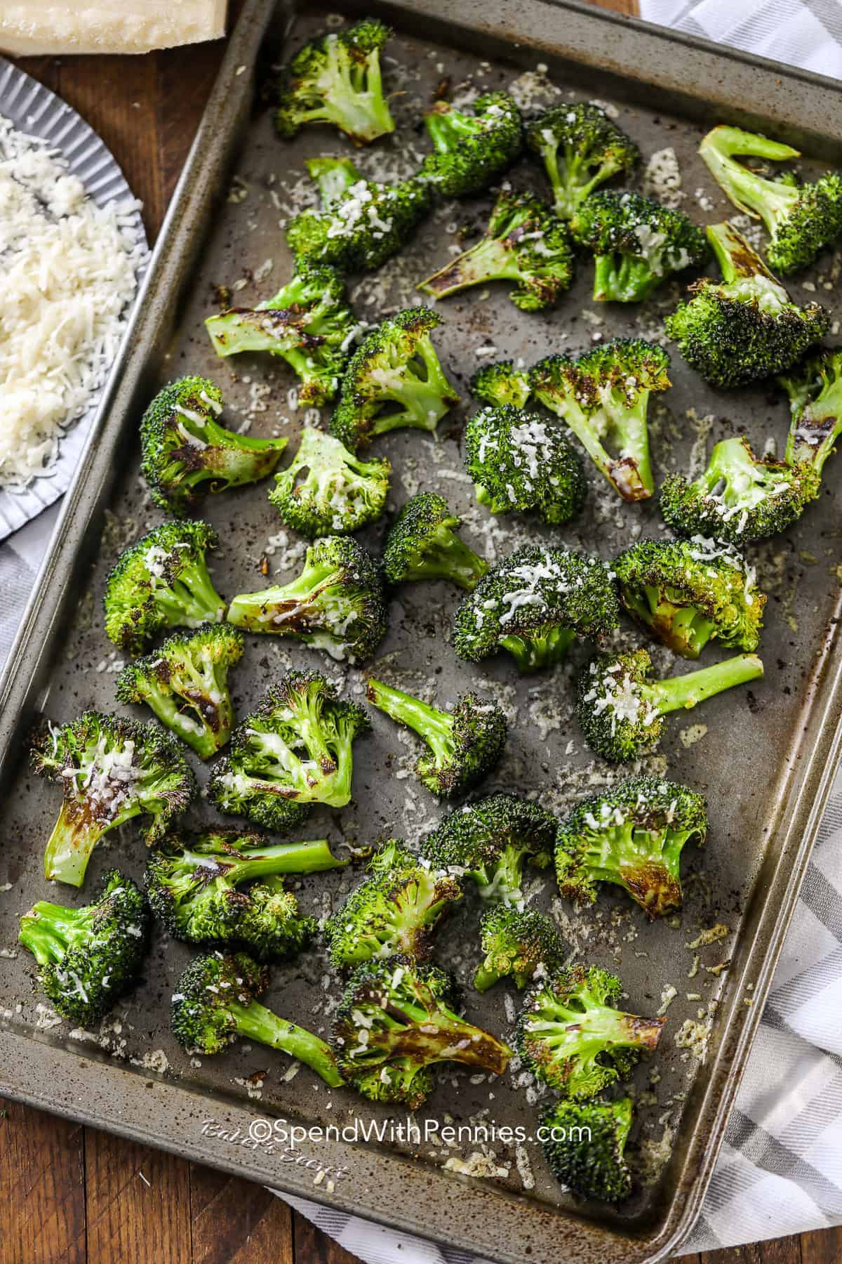 a pan of roasted broccoli with parmesan cheese