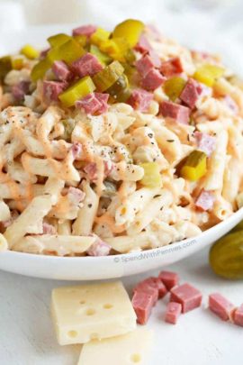 Reuben pasta salad topped with pickles and reuben chunks