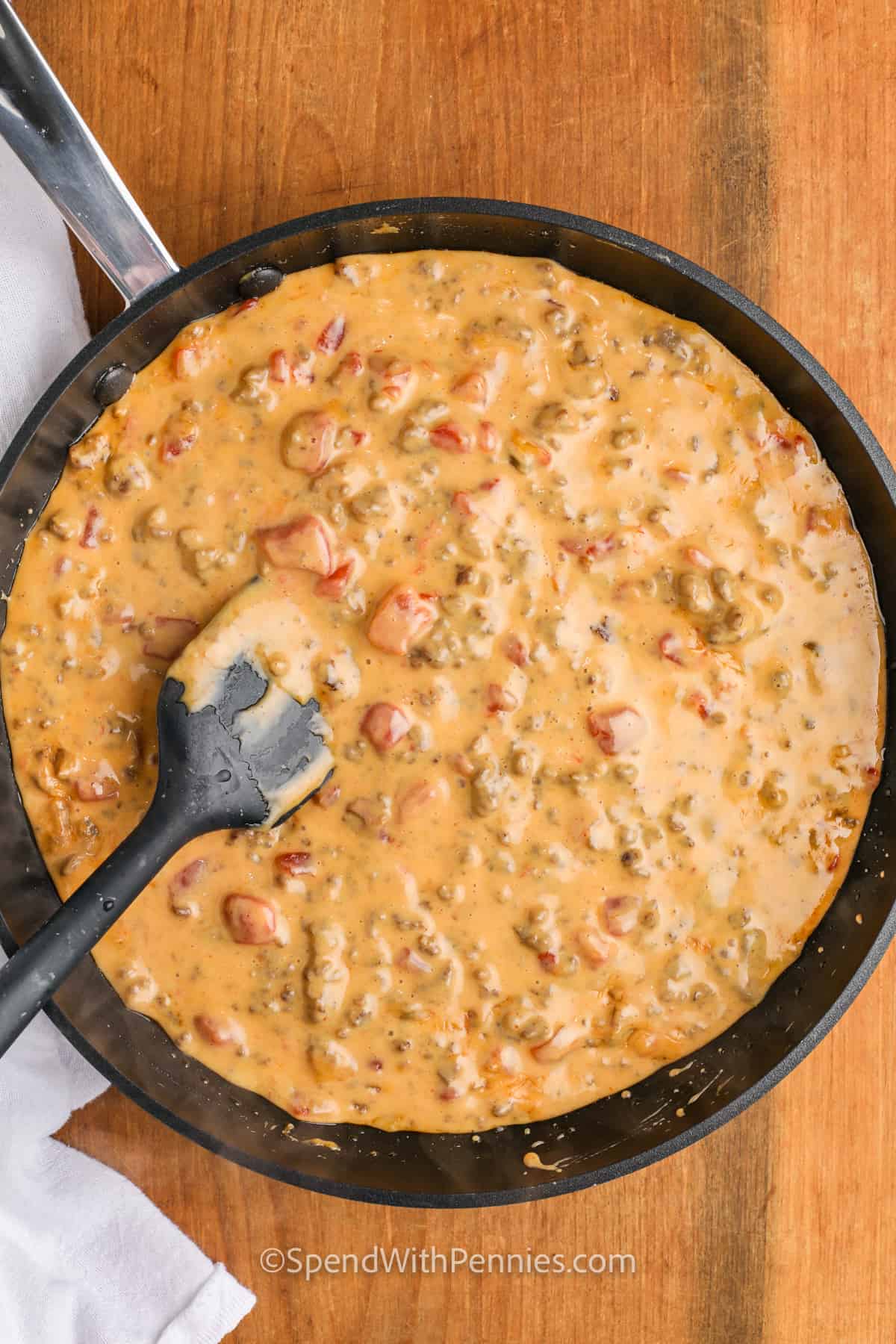 melting cheese with beef to make Rotel Dip