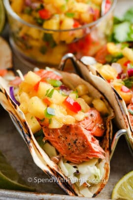 Salmon Tacos with Pineapple Salsa closeup of taco with salsa behind
