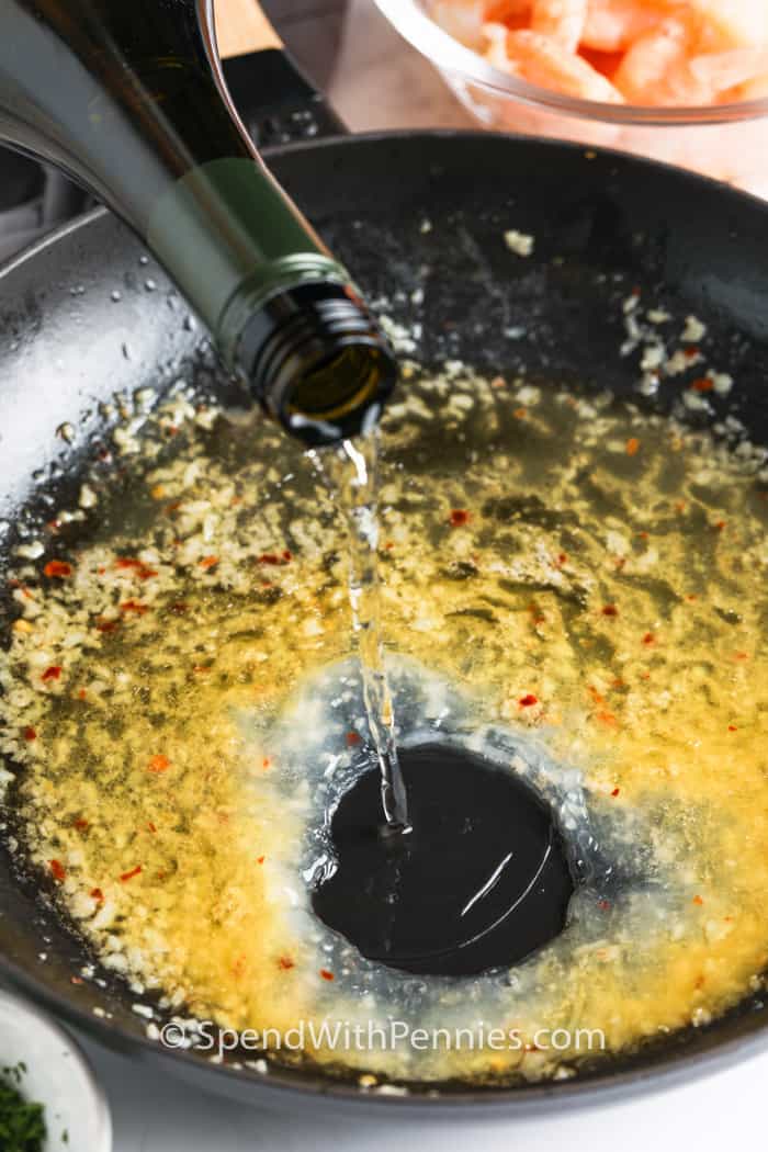 adding wine to pan to make Shrimp Scampi