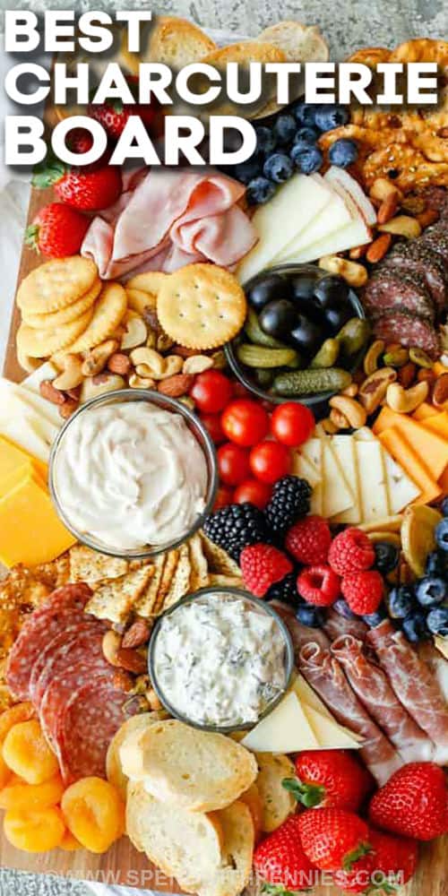 cheese , breads , fruits and other ingredients on a board with dips to show How to Make a Charcuterie Board with writing