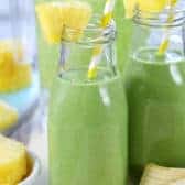 Green Smoothies in jars with straws and pineapple