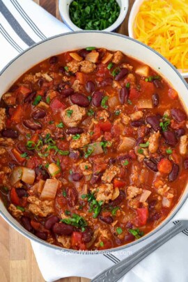 turkey chili in a pot with a bowl of cheese