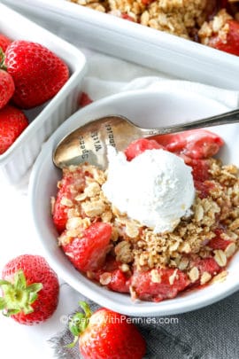 Strawberry Crisp with a vanilla ice cream in a bowl with a spoon