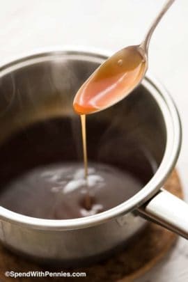 Sweet and sour sauce in a pot with a spoon