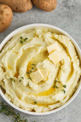 A bowl of mashed potatoes with butter