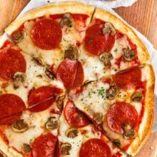 overhead view of a tortilla pizza with pepperoni and mushrooms