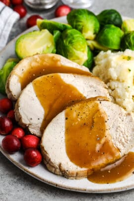 roast turkey breast on a plate with brussels sprouts